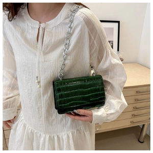 Detail view of dark green stone pattern crossbody bag with thick silver chain strap