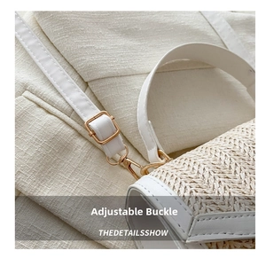 Detail of adjustable strap with gold-tone buckle on white straw crossbody bag