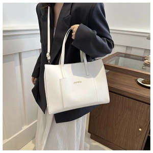 Close-up of white PU tote bag showing double handles and JINGPINPIJU logo detail