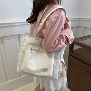 White minimalist large capacity canvas tote bag with front zipper and round patch