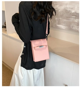 Close-up of pink leather crossbody phone bag featuring a classic metal twist lock buckle
