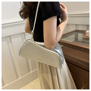 Close-up of silver irregular square bag with Fashion & Bags text and metal strap detail