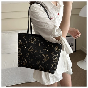 Large black tote bag with gold butterfly embroidery and comfortable shoulder straps