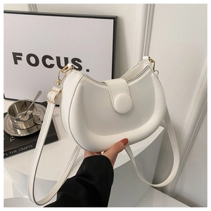 Detail of a white half-moon shoulder bag with matte leather and gold metal hooks