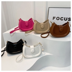 Minimalist solid color half-moon saddle bags in five colors displayed on white steps