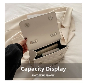Internal capacity display of the white quilted chain bag showing space for a smartphone