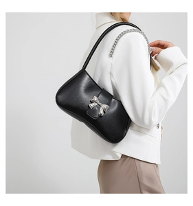 Detail der schwarzen Hobo-Tasche mit silberner Kette und Schleifenschnalle aus Metall
