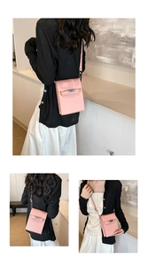 Close-up of pink litchi grain leather crossbody phone bag with metal twist lock