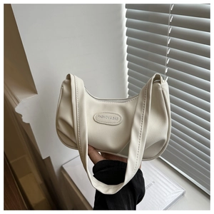 Close-up of the cream white pleated leather shoulder bag with embossed brand logo