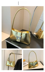 Detail der goldenen Metallic-Umhängetasche mit dekorativer silberner Metall-Schleife