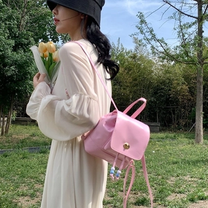 Pink mini backpack for women with beaded drawstring and gold rotating clasp detail