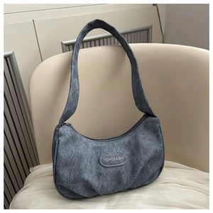 Close-up of grey washed texture hobo bag with Fashion & Bag label on a chair