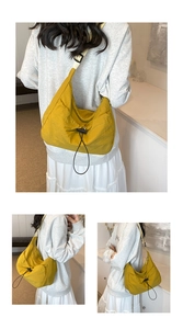 Detail of yellow crescent tote bag showing water-resistant fabric and drawstring design