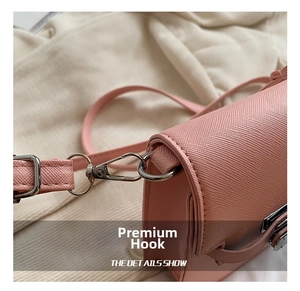 Detailed close-up of the durable silver metal hook and strap of the pink crossbody bag