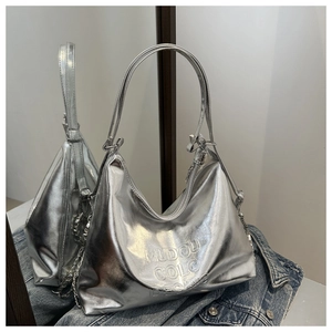 Detailed view of metallic silver hobo bag with wide shoulder strap and chain detail
