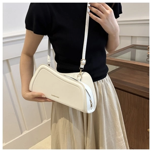 Detail of cream white PU leather shoulder bag with gold zipper and fashion text