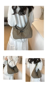 Detail view of olive nylon tote bag featuring adjustable strap and drawstring pockets