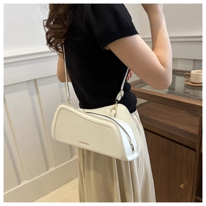 Detail of white glossy leather shoulder bag with FASHION & BAGS print and metal buckle