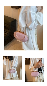 Detailed view of a pink glitter clutch bag with golden bow clasp and chain strap