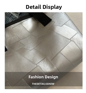 Detail of silver geometric patchwork bag showing leather texture and precision stitching
