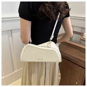 Detailed back view of a minimalist white shoulder bag featuring a sleek curved silhouette