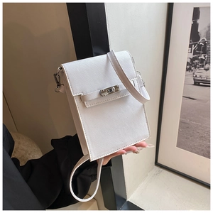 Close-up of a white textured leather mini crossbody bag with silver twist lock detail