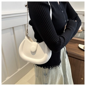 Detailed side view of the white saddle bag showing smooth leather texture and round buckle