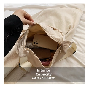 Macro view of beige tote bag interior showing large storage capacity and zipper