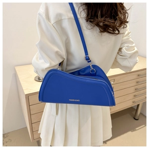 Detail of royal blue asymmetric leather shoulder bag with FASHION & BAGS lettering