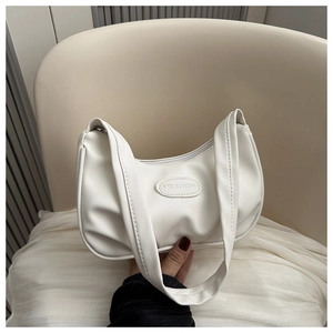 Close-up of white crescent moon bag showing pleated leather and FASHION & BAG metallic logo