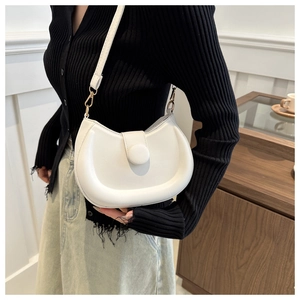 Detail of white semi-circular crossbody bag with round buckle and golden metal hook