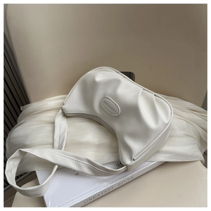 Detail of white pleated moon bag with PU leather texture and Fashion & Bag logo