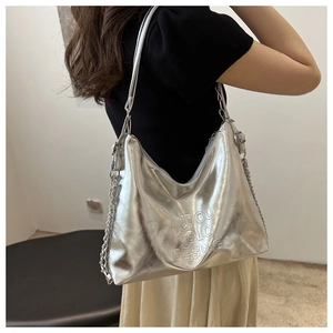 Detail of silver metallic PU leather hobo bag with embossed lettering and chain strap