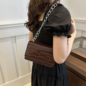 Chic dark brown crocodile pattern crossbody bag with a chunky silver chain strap