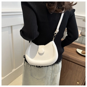 Detailed back view of a minimalist white half-moon crossbody bag with round buckle