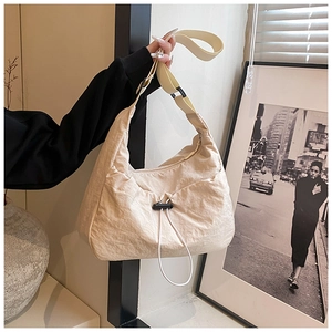 Detail of cream nylon crescent shoulder bag with drawstring ruching and wide strap