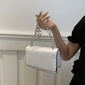 White faux leather crossbody bag with crocodile pattern and silver chain strap