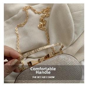 Close-up of champagne gold glitter evening bag with round metallic handle and fine chain