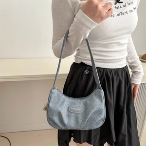 Minimalist light blue crescent underarm bag with pleated details and leather strap