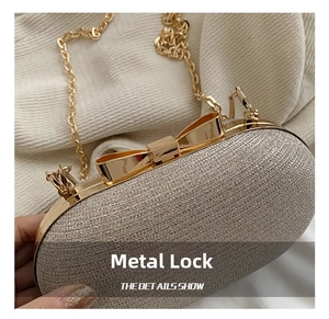 Close-up of sparkling silver sequin evening bag with elegant golden bow hardware clasp