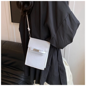 Crossbody phone bag with cross-grain leather texture and silver buckle detail on model