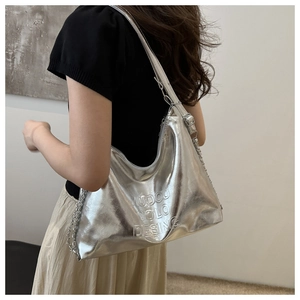Close-up of silver bucket bag with embossed lettering and metal chain strap detail