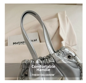 Silver drawstring bucket bag detail with pearl metal chain and soft pleated texture