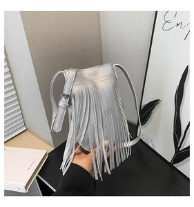 Detailed close-up of a silver fringe crossbody bag with metallic leather finish