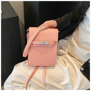 Detail of pink mini crossbody phone bag with metal rotating lock and cross grain leather