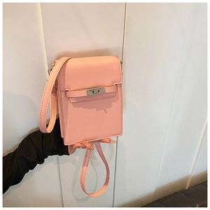 Close-up of pink Saffiano leather texture and silver twist lock on vertical mini bag