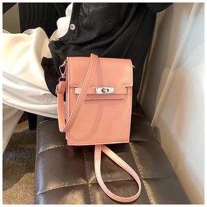 Detailed view of pink vertical crossbody phone bag with cross-grain leather and metal lock