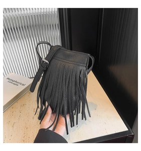 Detail of a black tassel shoulder bag featuring lycra-textured leather and silver metal buckles