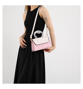 Detail of color-block crossbody bag with unique metallic handle and pink cream finish