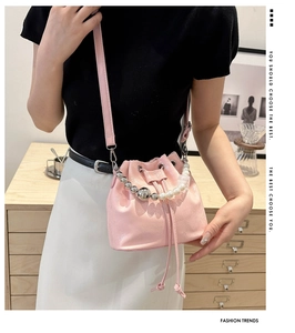 Detail of pink mini bucket bag with pearlescent beads and silver sphere handle